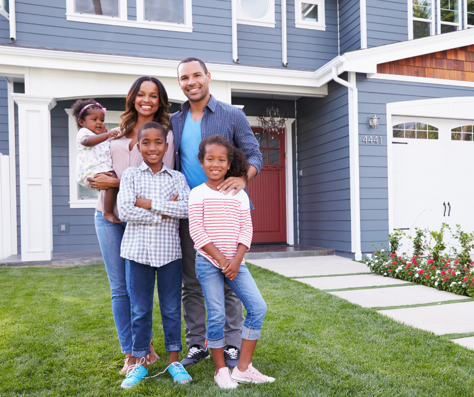 Happy family in front of home