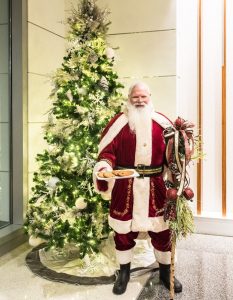 Santa standing by tree